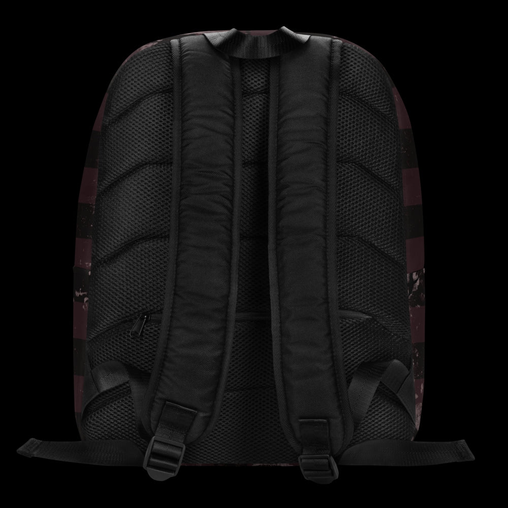 a grunge striped backpack in deep burgundy red and black, with a grungy collage that's visible close-up. 