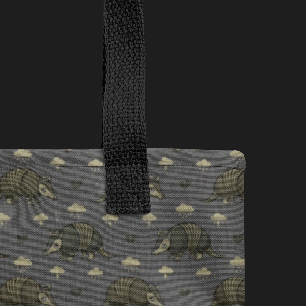 tote bag with an emo armadillo pattern with broken hearts and storm clouds in brownish grey