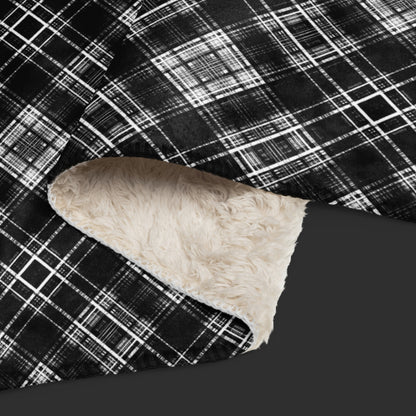 Large fleece sherpa blanket with a fuzzy distressed plaid pattern in black and white.
