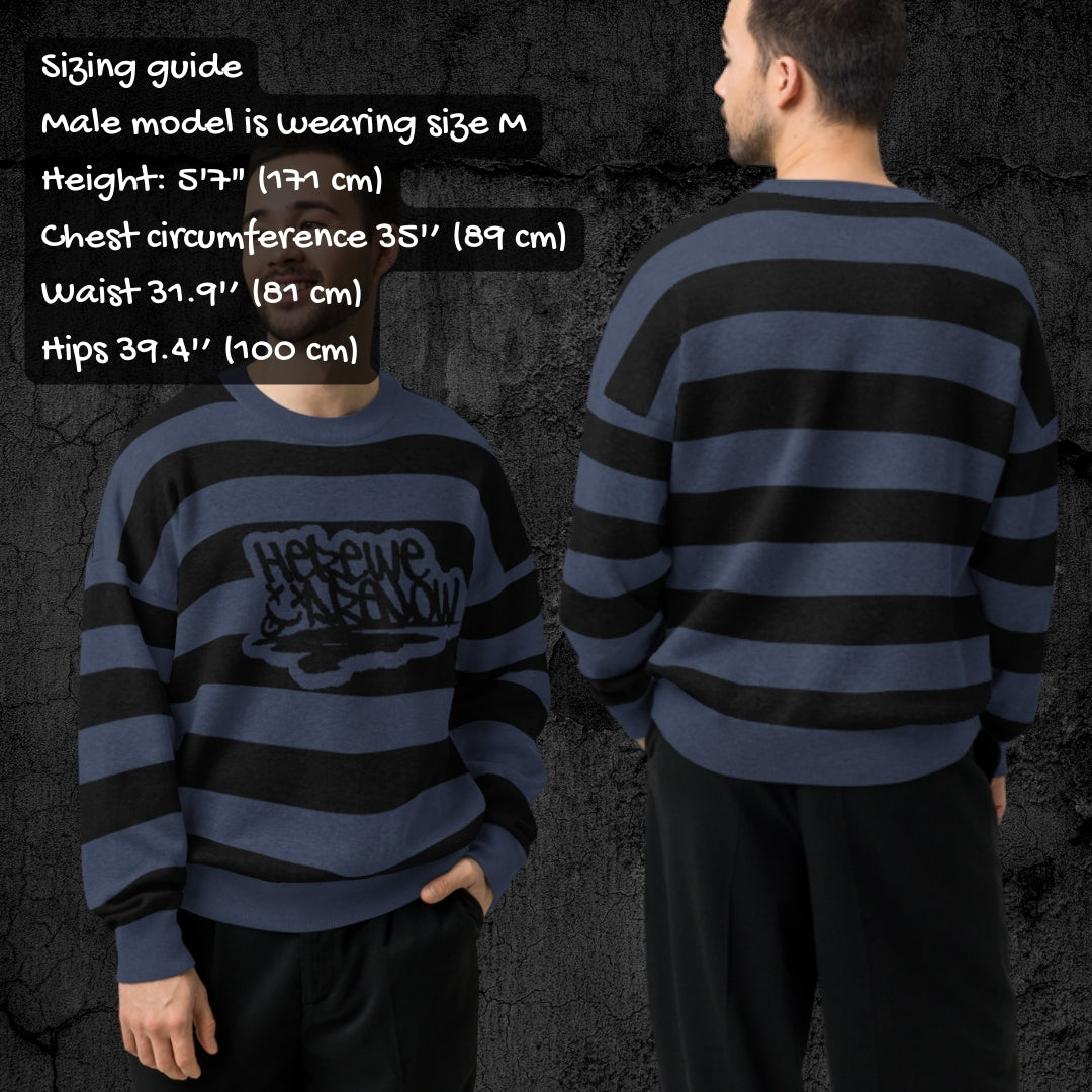 Two people wearing a blue and black striped grunge knitted sweater with sizing information displayed.