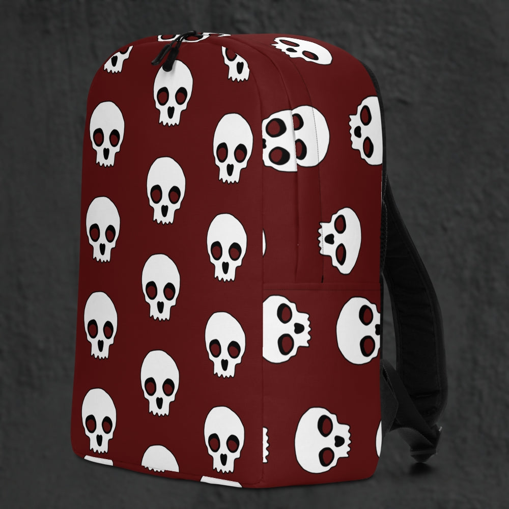 a backpack with a large skull pattern on deep red