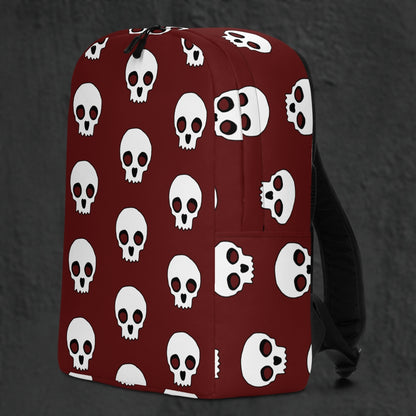 a backpack with a large skull pattern on deep red