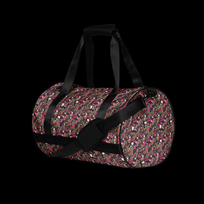 a duffel gym bag with a camo, paint splatter, and gritty skulls pattern in pink and purple shades