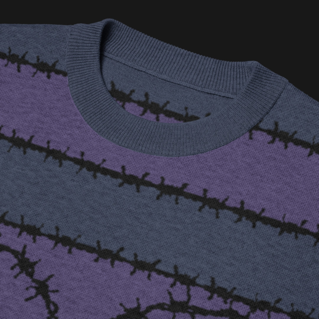 A jacquard knitted tee in dark moody shades, featuring stripes and a large heart lined with barbed wire