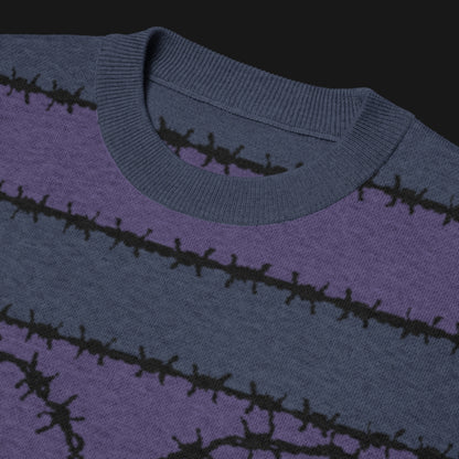 A jacquard knitted tee in dark moody shades, featuring stripes and a large heart lined with barbed wire