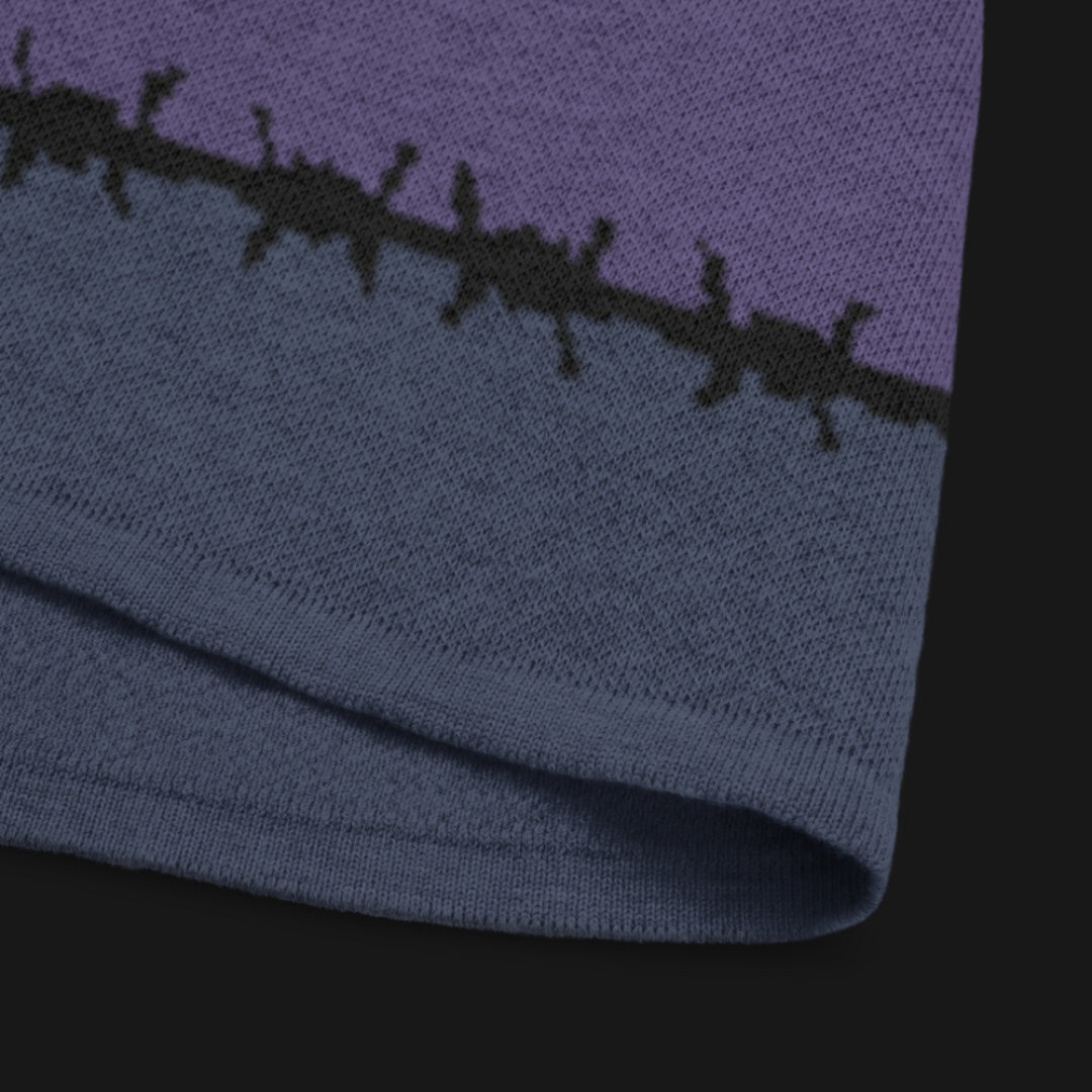 A jacquard knitted tee in dark moody shades, featuring stripes and a large heart lined with barbed wire