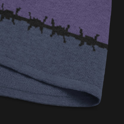 A jacquard knitted tee in dark moody shades, featuring stripes and a large heart lined with barbed wire