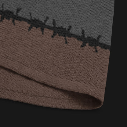 A jacquard knitted tee in dark moody shades, featuring stripes and a large heart lined with barbed wire