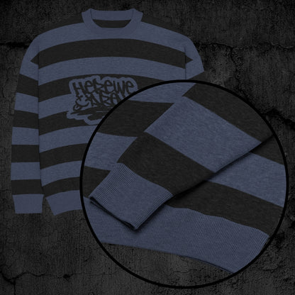 Black and blue grunge striped knitted sweater with a text "here we are now" in graffiti tag style, on a dark textured background