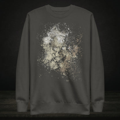 A cotton heritage M2480 sweatshirt with a subtle skull graphic surrounded and overlaid with paint splatter in camouflage colors on vintage black