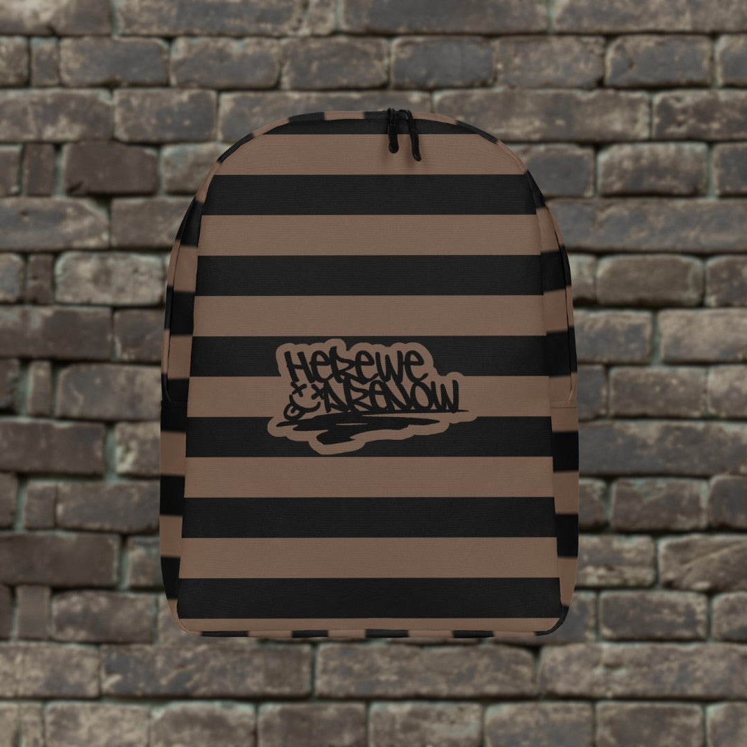 Backpack with brown and black grunge style dark stripes and text "here we are now" in graffiti tag style