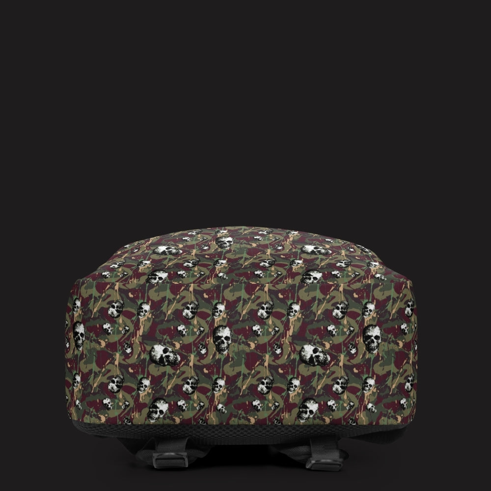 a backpack with a camo and paint and gritty skulls pattern in burgundy and green