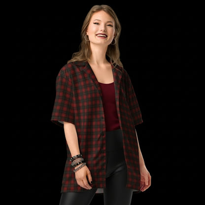 Alt style person wearing a dark punk tartan pattern short sleeve shirt with back print Punks not dead.