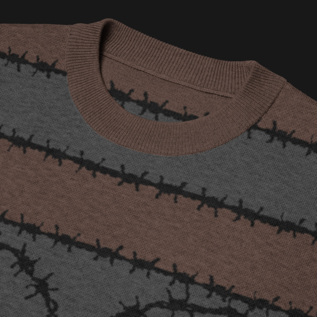 A jacquard knitted tee in dark moody shades, featuring stripes and a large heart lined with barbed wire