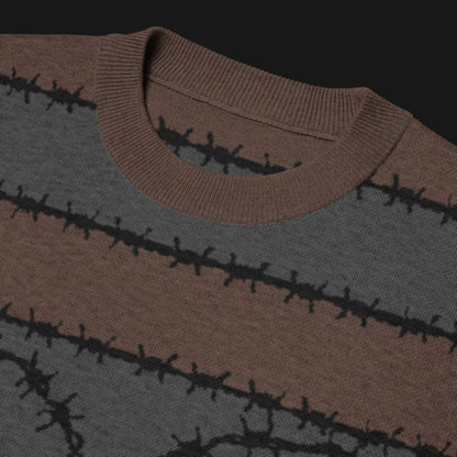 A jacquard knitted tee in dark moody shades, featuring stripes and a large heart lined with barbed wire