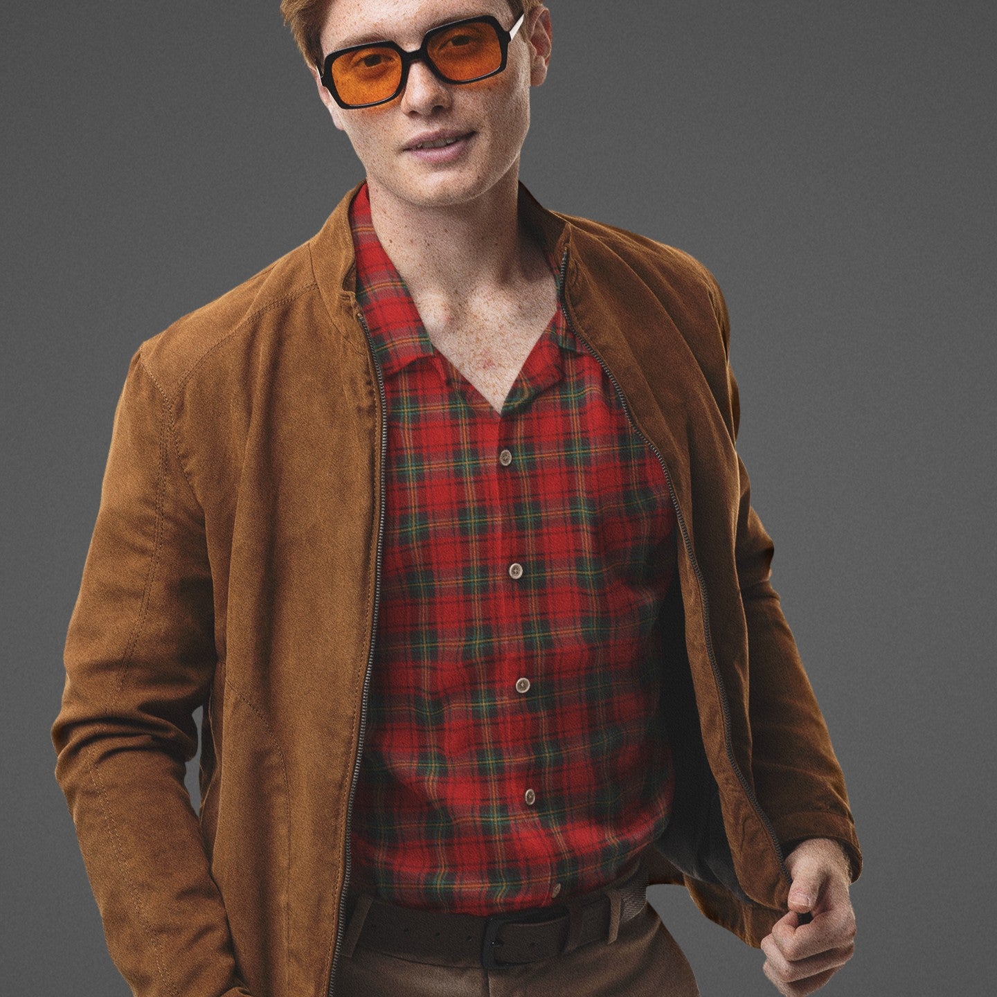 man wearing a red punk tartan plaid button-up under a retro jacket