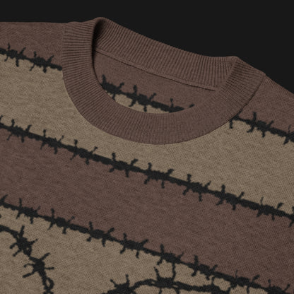 A jacquard knitted tee in dark moody shades, featuring stripes and a large heart lined with barbed wire