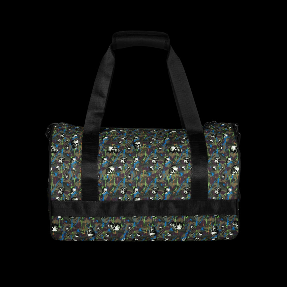a duffel gym bag with a camo, paint splatter, and gritty skulls pattern in green and neon shades