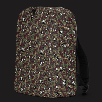 a backpack with a camo and paint and gritty skulls pattern in burgundy and green