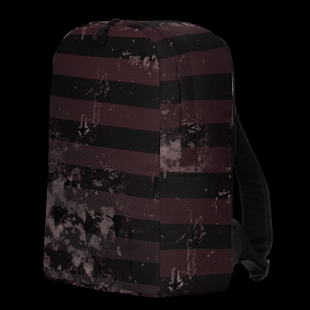 a grunge striped backpack in deep burgundy red and black, with a grungy collage that's visible close-up. 