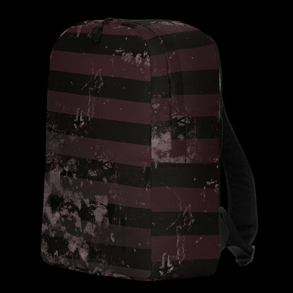 a grunge striped backpack in deep burgundy red and black, with a grungy collage that's visible close-up. 