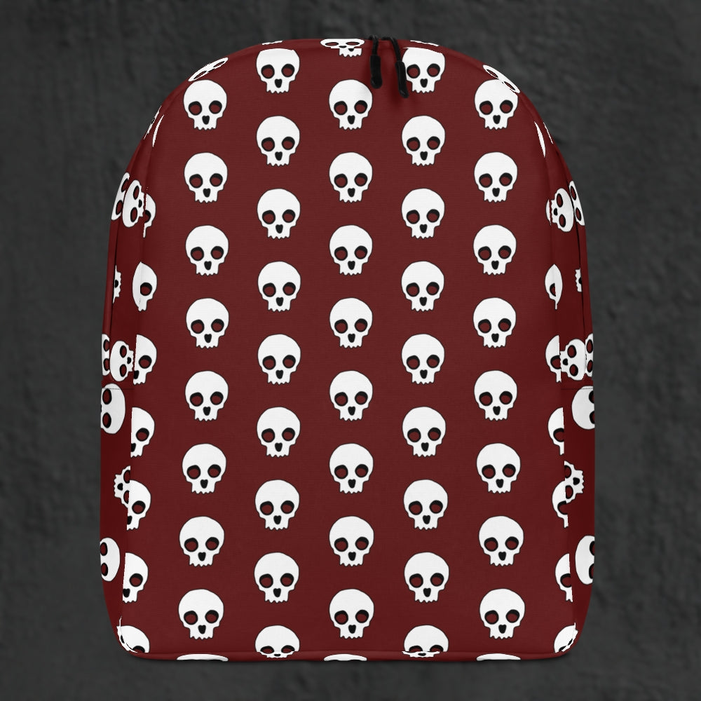 a backpack with a large skull pattern on deep red