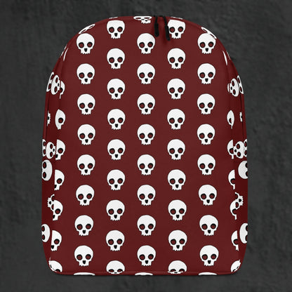 a backpack with a large skull pattern on deep red