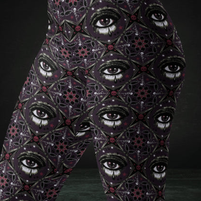 Purple kaleidoscope like leggings with crying eyes and emo symbols