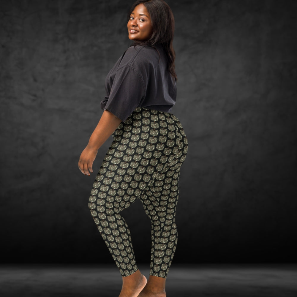 Person wearing leggings with camouflage colored pumpkins on black background