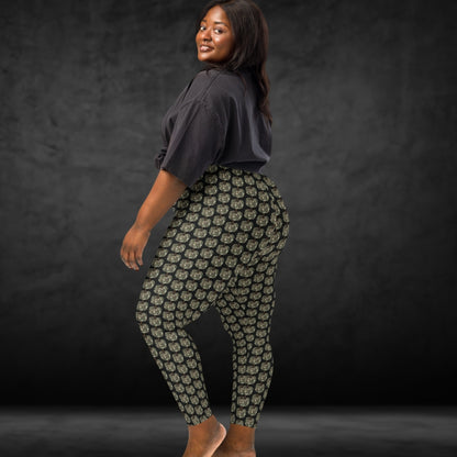 Person wearing leggings with camouflage colored pumpkins on black background