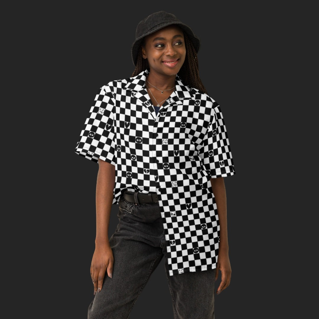 Person wearing a black and white checkered button up shirt with emo symbols