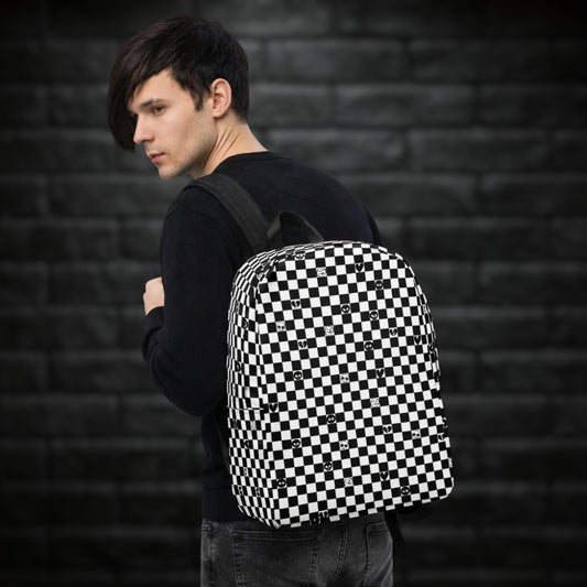 Man carrying a backpack with black and white checkers, and with emo symbols in some of the white squares 