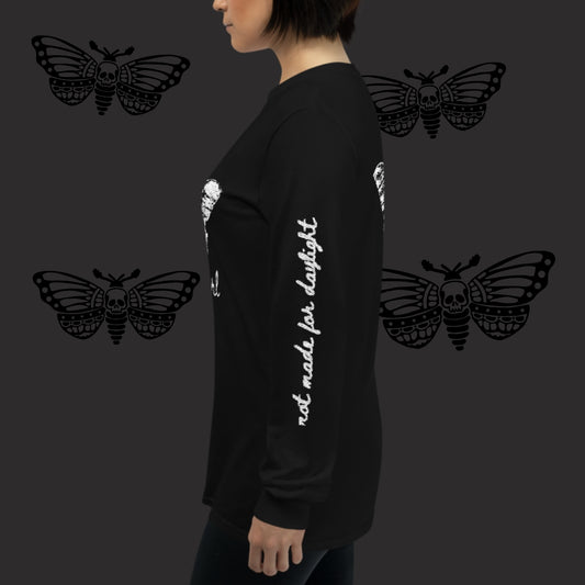 a woman wearing a black long sleeve tee with moth girl print in front and back and text on sleeves