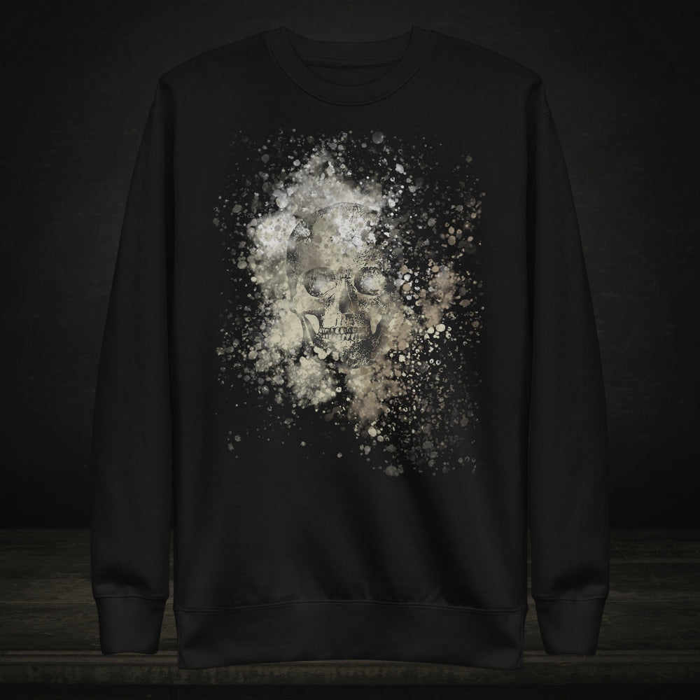 A black cotton heritage M2480 sweatshirt with a subtle skull graphic surrounded and overlaid with paint splatter in camouflage colors