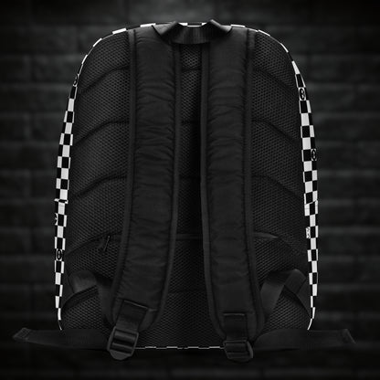 A backpack with black and white checkers, and with emo symbols in some of the white squares 