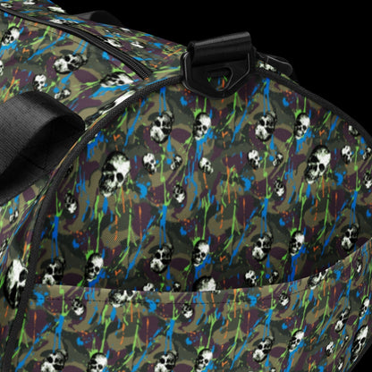 a duffel gym bag with a camo, paint splatter, and gritty skulls pattern in green and neon shades