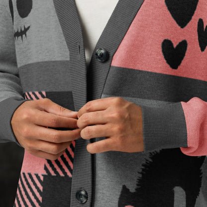 A pink, grey and black knitted cardigan with patchwork pattern areas