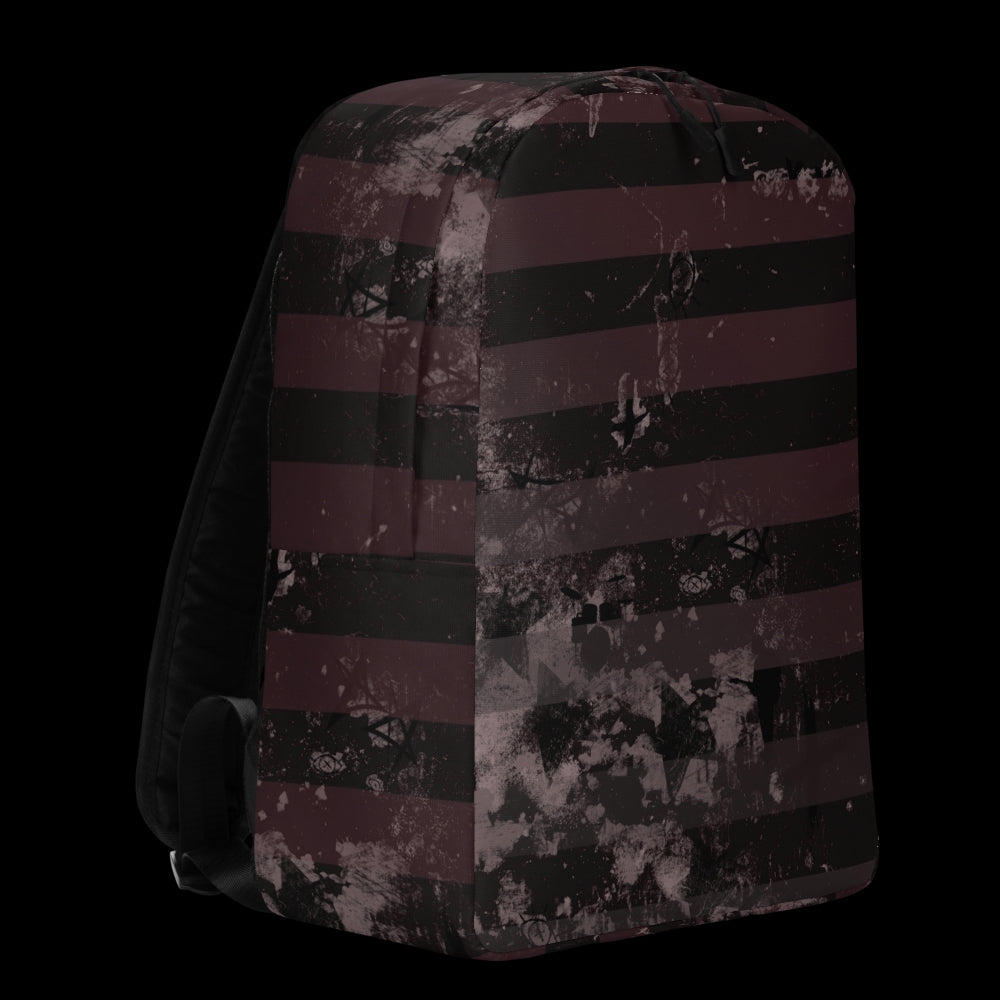 a grunge striped backpack in deep burgundy red and black, with a grungy collage that's visible close-up. 