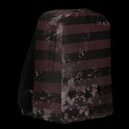 a grunge striped backpack in deep burgundy red and black, with a grungy collage that's visible close-up. 