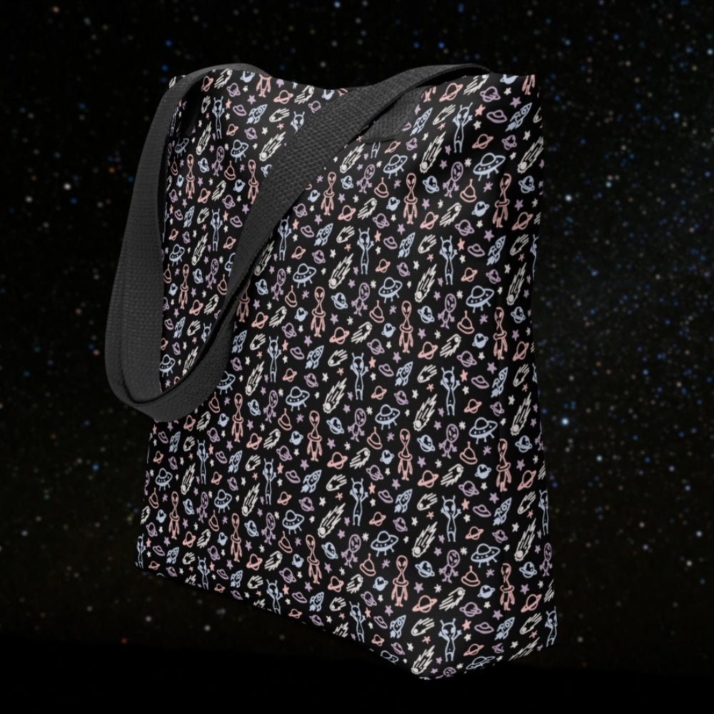 Tote bag with a cool hand drawn space pattern with confused aliens and planets in pastel on black