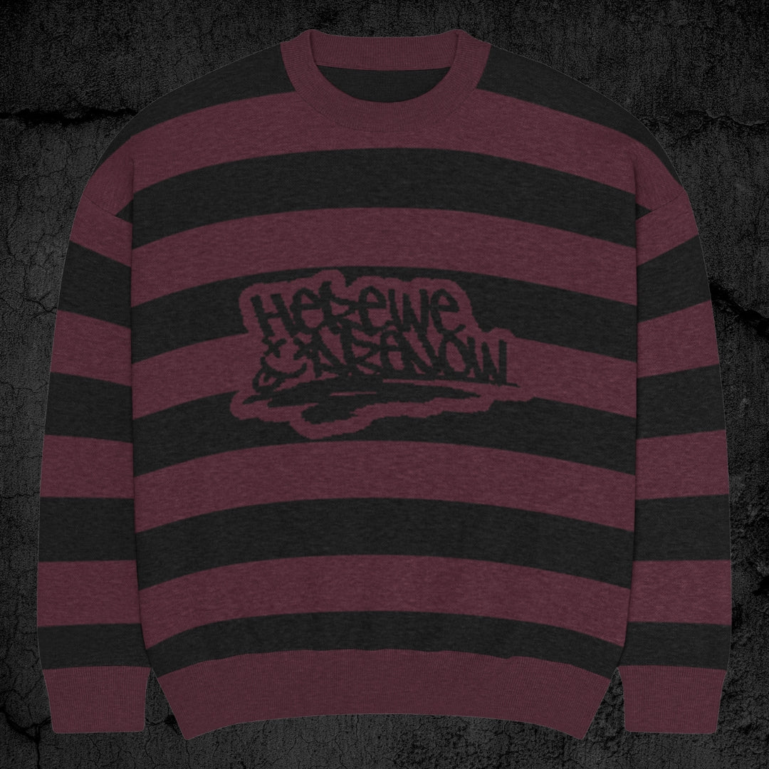 Black and burgundy grunge striped knitted sweater with a text "here we are now" in graffiti tag style, on a dark textured background