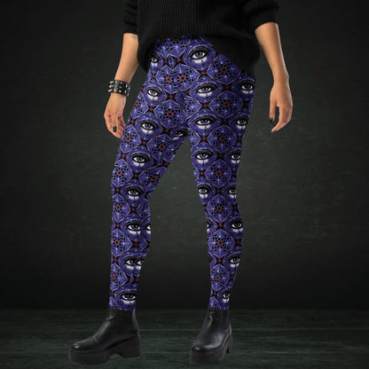 person wearing blue kaleidoscope like leggings with crying eyes and emo symbols