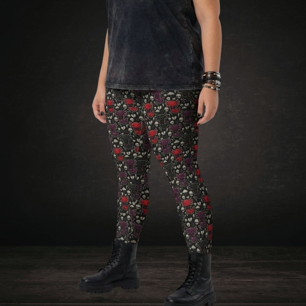 Alt style person wearing leggings with red and purple emo axolotls.