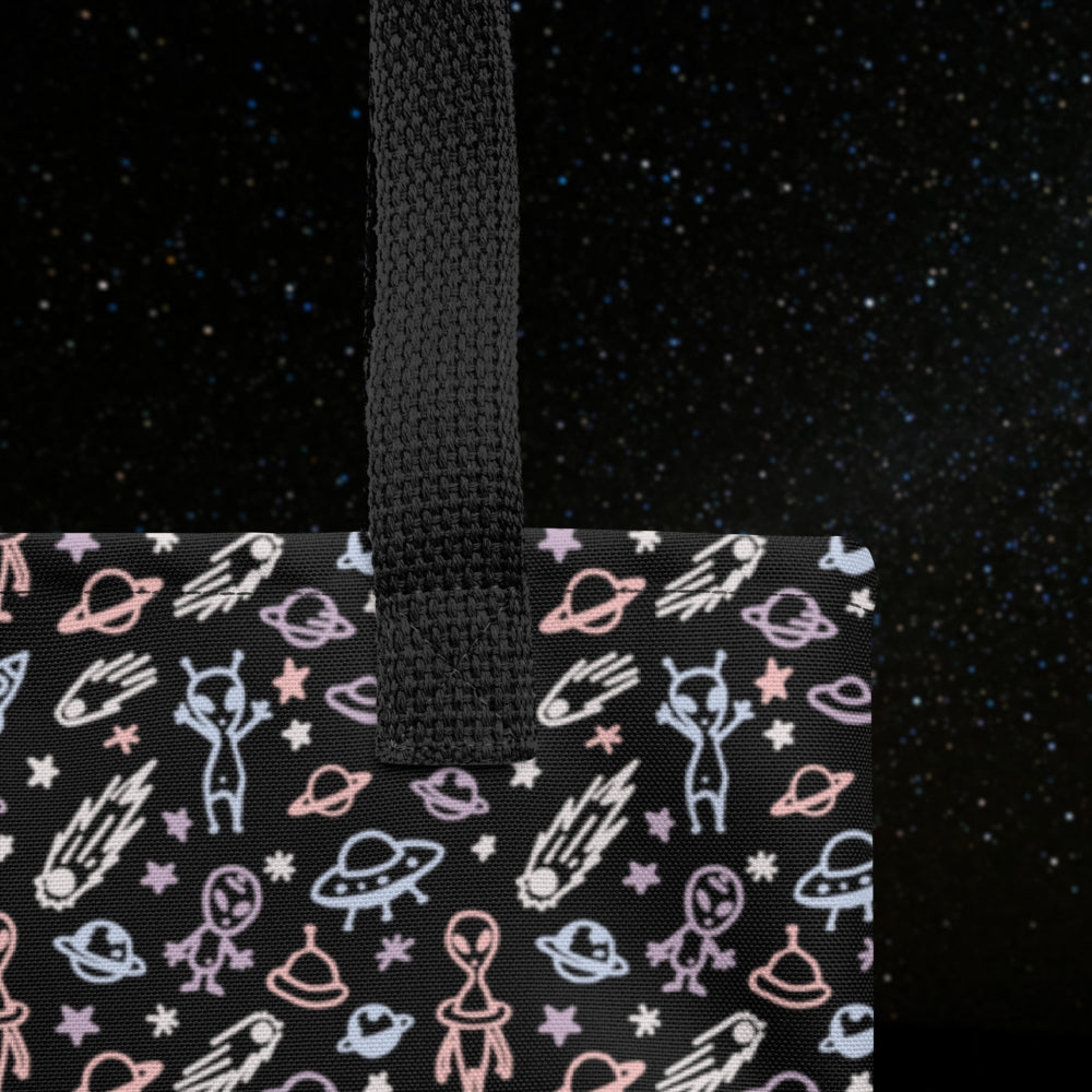 Tote bag with a cool hand drawn space pattern with confused aliens and planets in pastel on black