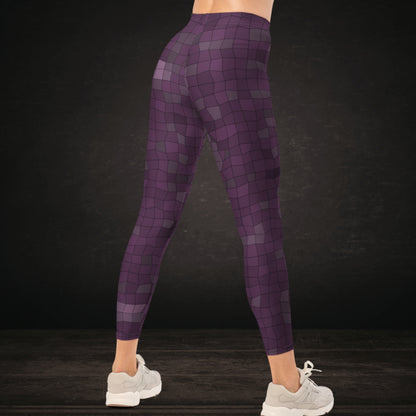 Person wearing leggings with an irregular distorted mosaic pattern in purple shades