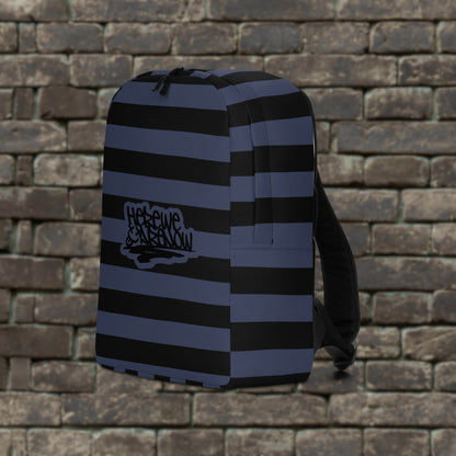Backpack with blue and black grunge style dark stripes and text "here we are now" in graffiti tag style