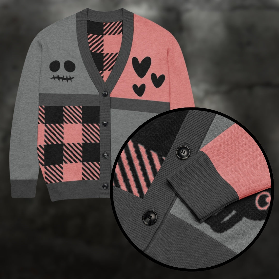 A pink, grey and black knitted cardigan with patchwork pattern areas