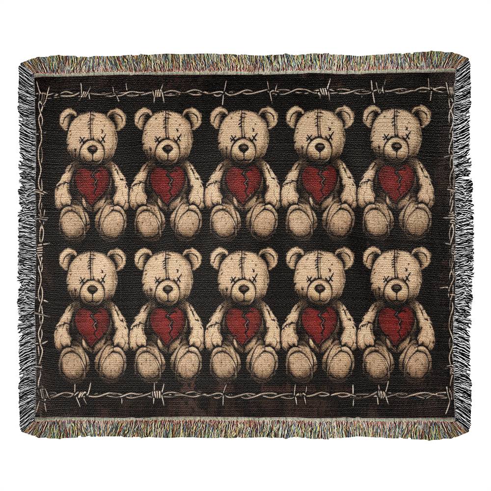 a woven blanket with x-eyed teddy bears on a dark background and surrounded by a frame of barbed wire