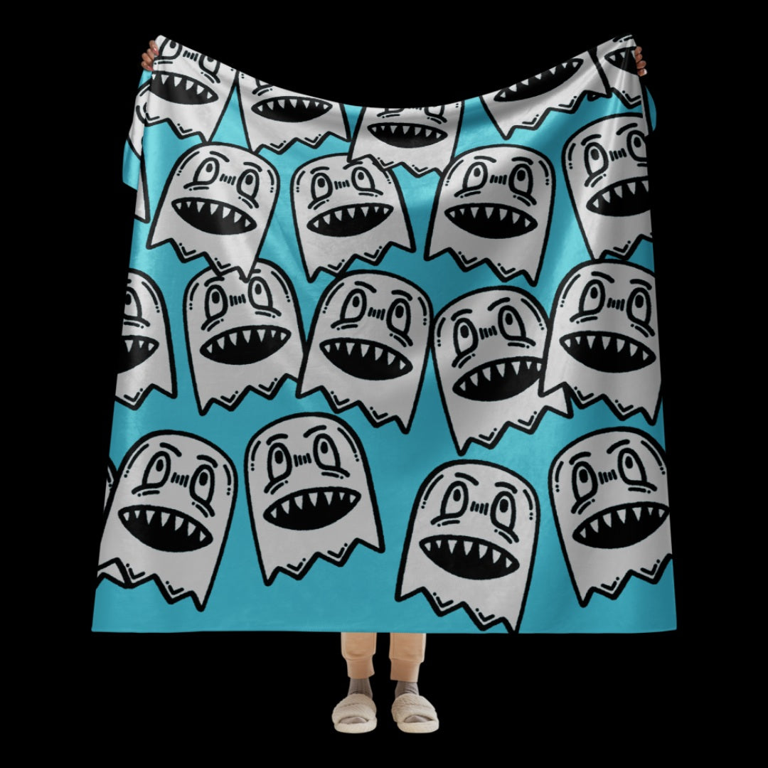 a large sky blue fleece sherpa blanket with grinning goblins