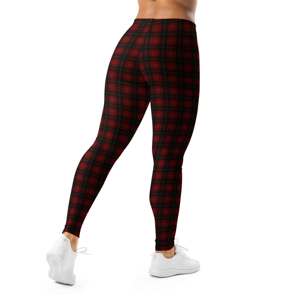 Red and black plaid leggings worn by a person on a white background
